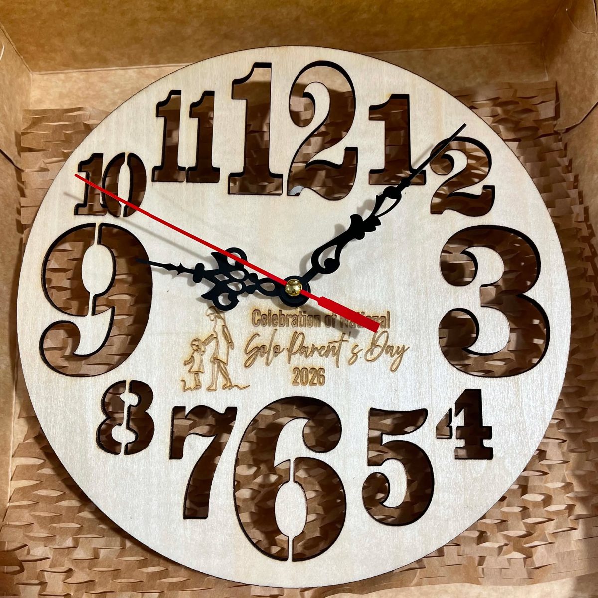 Laser-cut plywood wall clock with engraved design
